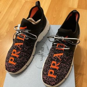 Prada Calzature Donna stretch-knit sneakers with logo embroidery.